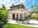 Outdoor entertaining space featuring a dining area, outdoor kitchen, covered patio, and lounge chairs at 4129 Roberts Point Cir, Sarasota, FL 34242
