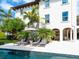 Tropical backyard featuring pool, lounge chairs, outdoor seating, and lush landscaping at 4129 Roberts Point Cir, Sarasota, FL 34242