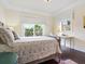 Sunlit bedroom features a large window, dark wood floors, and neutral wall color at 4129 Roberts Point Cir, Sarasota, FL 34242
