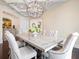 Dining room showcasing an ornate wood table, tufted chairs, and detailed ceiling fixture at 4129 Roberts Point Cir, Sarasota, FL 34242