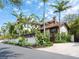 Charming home exterior with a tile roof, lush landscaping, and a private driveway offering curb appeal at 4129 Roberts Point Cir, Sarasota, FL 34242