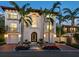 Grand two-story home boasting a tiled roof, water feature and meticulously maintained front yard and garage at 4129 Roberts Point Cir, Sarasota, FL 34242