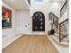 Elegant foyer featuring a staircase, arched doorway, and decorative rug at 4129 Roberts Point Cir, Sarasota, FL 34242