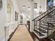 Spacious foyer with hardwood floors, decorative columns, and a wrought iron staircase at 4129 Roberts Point Cir, Sarasota, FL 34242