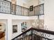Grand foyer with wrought iron railing and a view of the living room below at 4129 Roberts Point Cir, Sarasota, FL 34242