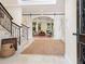 Elegant foyer with a staircase, sliding barn doors, and access to the living room at 4129 Roberts Point Cir, Sarasota, FL 34242