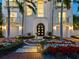 A beautiful front entrance features a grand door, fountain, flowerbeds and symmetrical palm trees at 4129 Roberts Point Cir, Sarasota, FL 34242