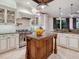 Gourmet kitchen featuring custom cabinets, marble countertops, a large island, and stainless steel appliances at 4129 Roberts Point Cir, Sarasota, FL 34242