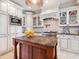 Beautiful kitchen with a center island, custom cabinets, modern appliances, and ample counter space at 4129 Roberts Point Cir, Sarasota, FL 34242