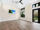 Bright living room with vaulted ceilings, hardwood floors, modern fixtures, and ample natural light at 4129 Roberts Point Cir, Sarasota, FL 34242