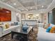 Bright living room with white sofas, dark wood floors, and view to kitchen at 4129 Roberts Point Cir, Sarasota, FL 34242