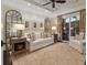Cozy living room with plush seating, neutral decor, and a sliding glass door to the outside at 4129 Roberts Point Cir, Sarasota, FL 34242