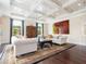 Comfortable living room with hardwood floors, neutral furniture, decorative accents, and large windows at 4129 Roberts Point Cir, Sarasota, FL 34242