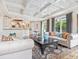 Living room with open layout, hardwood floors, stylish furniture, and views of the kitchen and outdoor areas at 4129 Roberts Point Cir, Sarasota, FL 34242