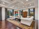 Cozy living room with hardwood floors, decorative ceiling, and large windows overlooking the outdoors at 4129 Roberts Point Cir, Sarasota, FL 34242