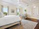 Bright primary bedroom boasting an ornate ceiling and neutral decor with accents of blue at 4129 Roberts Point Cir, Sarasota, FL 34242