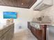 Outdoor kitchen includes grill, mini-fridge, cabinets, and counter space for cooking and entertaining at 4129 Roberts Point Cir, Sarasota, FL 34242