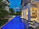 Resort-style pool featuring a covered patio, lounge chairs and meticulous landscaping at 4129 Roberts Point Cir, Sarasota, FL 34242