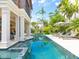 A beautiful swimming pool with a spa and outdoor seating area surrounded by lush tropical landscaping at 4129 Roberts Point Cir, Sarasota, FL 34242