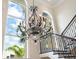 Elegant staircase with ornate iron railings with large windows, providing natural light at 4129 Roberts Point Cir, Sarasota, FL 34242