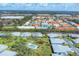 Aerial view displaying houses with well-maintained lawns and colorful roofs amidst lush greenery at 4220 Center Pointe Ln # 21, Sarasota, FL 34233
