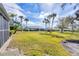Expansive backyard with lush green grass and tropical palm trees surrounding the property at 4220 Center Pointe Ln # 21, Sarasota, FL 34233