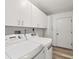 Convenient laundry room featuring a washer, dryer, and built-in cabinets at 4220 Center Pointe Ln # 21, Sarasota, FL 34233