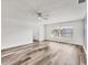 Clean living room featuring laminate flooring, large window, and a ceiling fan at 4220 Center Pointe Ln # 21, Sarasota, FL 34233