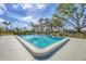 Community pool surrounded by lush landscaping and mature trees in a tranquil setting at 4220 Center Pointe Ln # 21, Sarasota, FL 34233