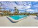 Community pool with sparkling blue water, surrounded by a concrete deck and chain link fence at 4220 Center Pointe Ln # 21, Sarasota, FL 34233