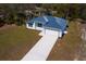 Aerial view of a modern, single-story home with a metal roof and long driveway at 4240 Adelaide Ave, North Port, FL 34288