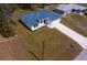 An aerial view showcasing the modern home design, long driveway, and surrounding landscape at 4240 Adelaide Ave, North Port, FL 34288