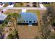 An aerial view showcasing the back of the home with an outdoor patio and a long driveway at 4240 Adelaide Ave, North Port, FL 34288