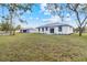 View of home's backyard, featuring a well-maintained lawn, and a back patio at 4240 Adelaide Ave, North Port, FL 34288