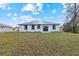View of home's backyard, featuring a well-maintained lawn, and a back patio at 4240 Adelaide Ave, North Port, FL 34288