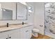 Elegant bathroom featuring double sinks, granite counters, and a marble-tiled shower at 4240 Adelaide Ave, North Port, FL 34288