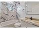 Bright bathroom featuring marble-tiled shower, and a single sink at 4240 Adelaide Ave, North Port, FL 34288