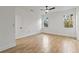 Bedroom with wood-look tile flooring, white walls, and two large windows at 4240 Adelaide Ave, North Port, FL 34288