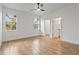 Bedroom with wood-look tile flooring, white walls, and two large windows at 4240 Adelaide Ave, North Port, FL 34288