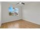 Bright bedroom with wood-look flooring and a large window offering neighborhood views at 4240 Adelaide Ave, North Port, FL 34288