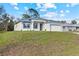 Beautiful single-story home featuring a modern design, well-manicured lawn, and a two-car garage at 4240 Adelaide Ave, North Port, FL 34288