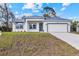 Charming single-story home featuring a modern design, well-manicured lawn, and a two-car garage at 4240 Adelaide Ave, North Port, FL 34288