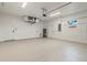 This is an attached two-car garage with epoxy flooring, white walls, and modern fixtures at 4240 Adelaide Ave, North Port, FL 34288