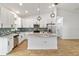 Modern kitchen with stainless appliances, a center island, granite countertops, and decorative backsplash at 4240 Adelaide Ave, North Port, FL 34288