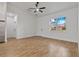 Living room featuring wood-look tile flooring, white walls, and a large window at 4240 Adelaide Ave, North Port, FL 34288
