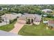 Aerial view of a beautiful home with a brick driveway, lush greenery, and waterfront access at 4386 Library St, Port Charlotte, FL 33948