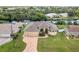 Aerial view of a well-maintained home featuring a three-car garage, pristine landscaping, and canal access at 4386 Library St, Port Charlotte, FL 33948