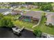 Aerial view of backyard with screened pool, boat dock, and lift on the canal at 4386 Library St, Port Charlotte, FL 33948