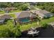 A beautiful backyard featuring a screened-in pool, boat dock and lift on the canal at 4386 Library St, Port Charlotte, FL 33948