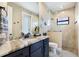 Modern bathroom with granite countertop, walk-in shower, and tiled floor at 4386 Library St, Port Charlotte, FL 33948